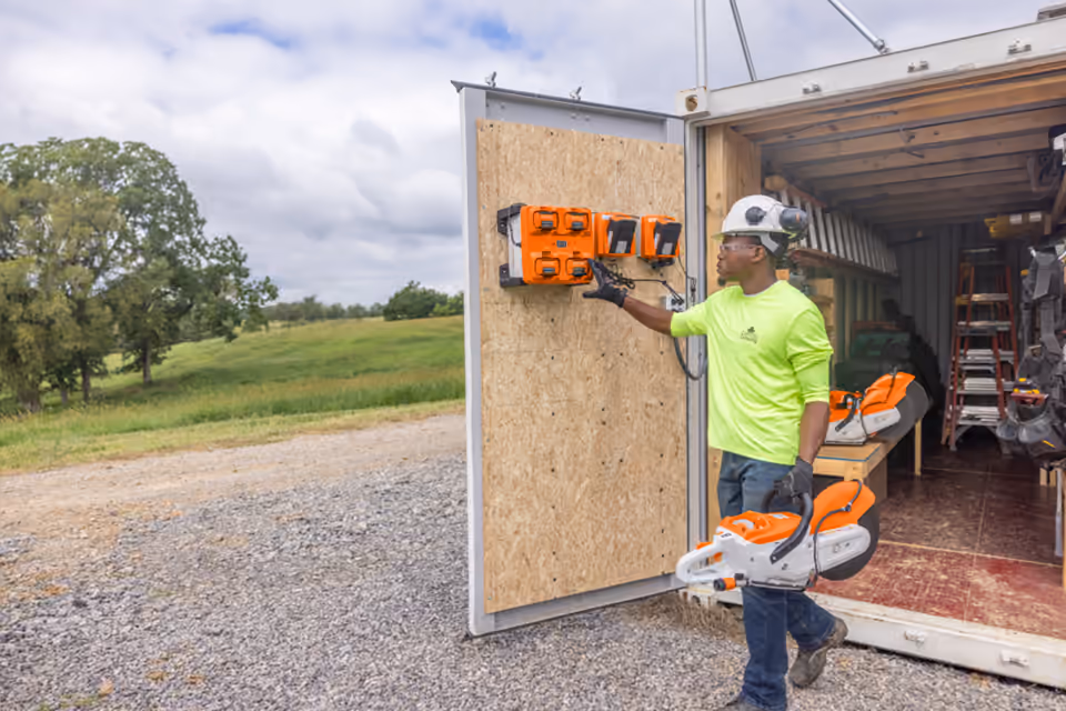 Worker with a STIHL battery cut-off machine on a jobsite