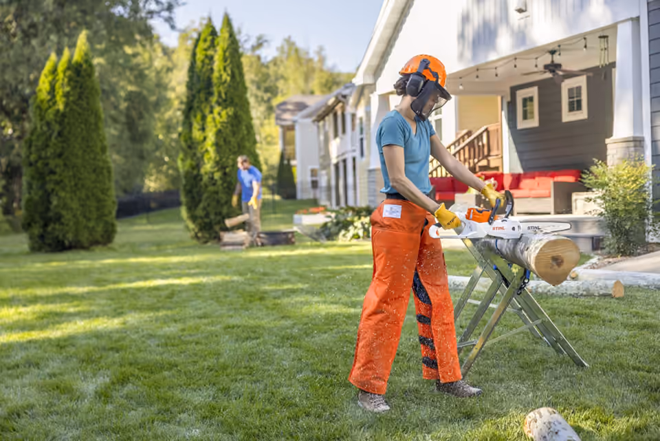 STIHL battery chainsaw cutting a supported log