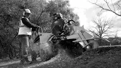 Operator using engine-powered jobsite earthworking equipment